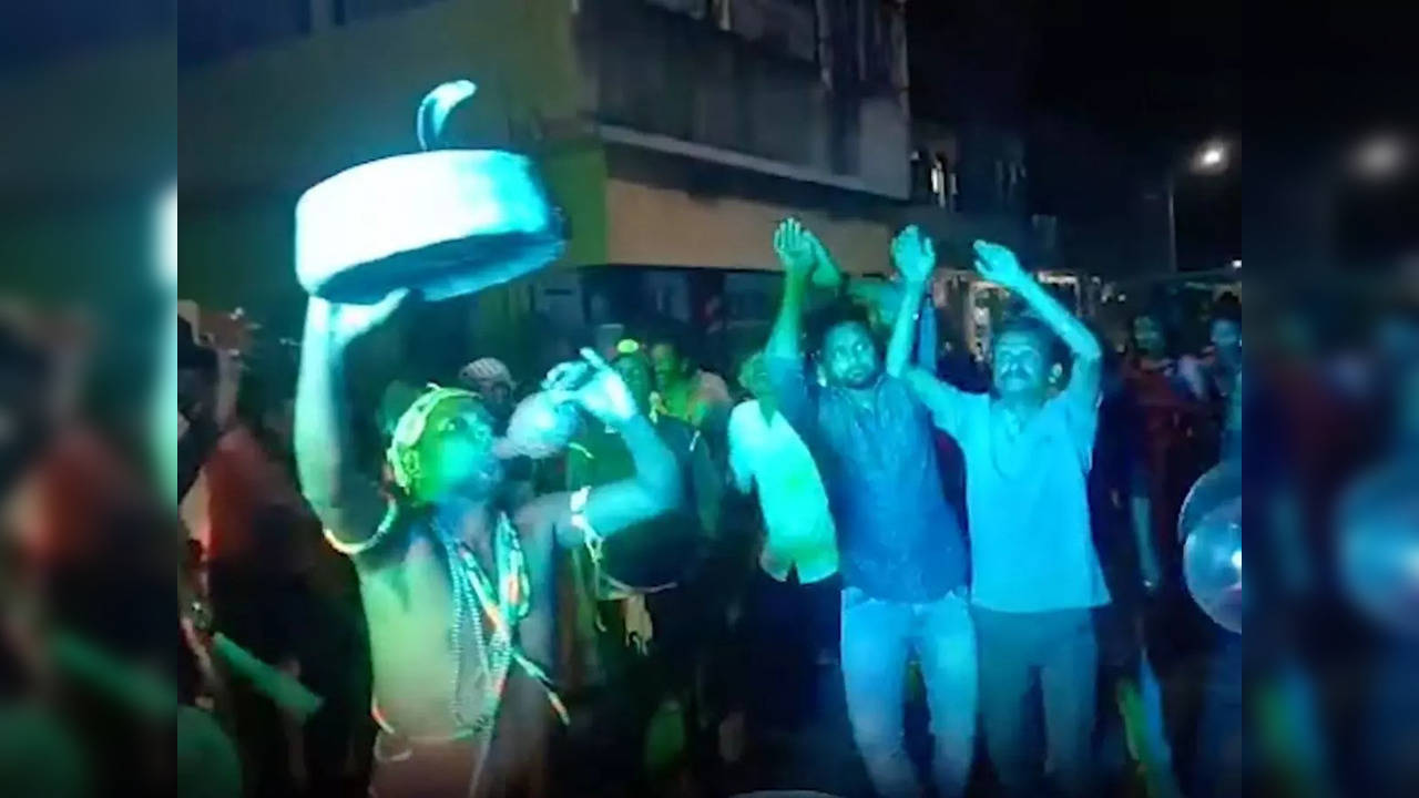 People dance in the presence of a highly-venomous cobra for a special 'Nagin dance' performance in Odisha