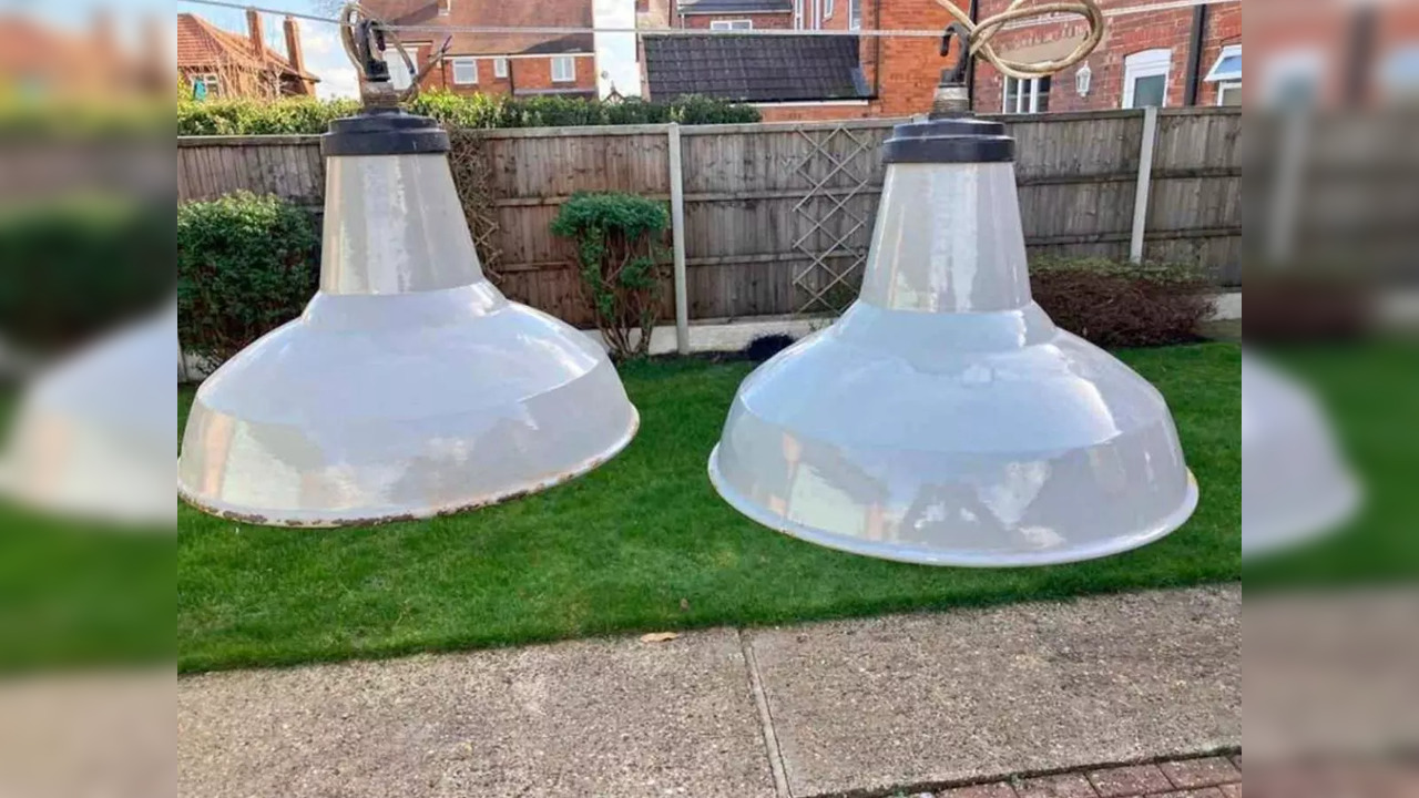 Optical illusion depicting oversized lamps in a yard