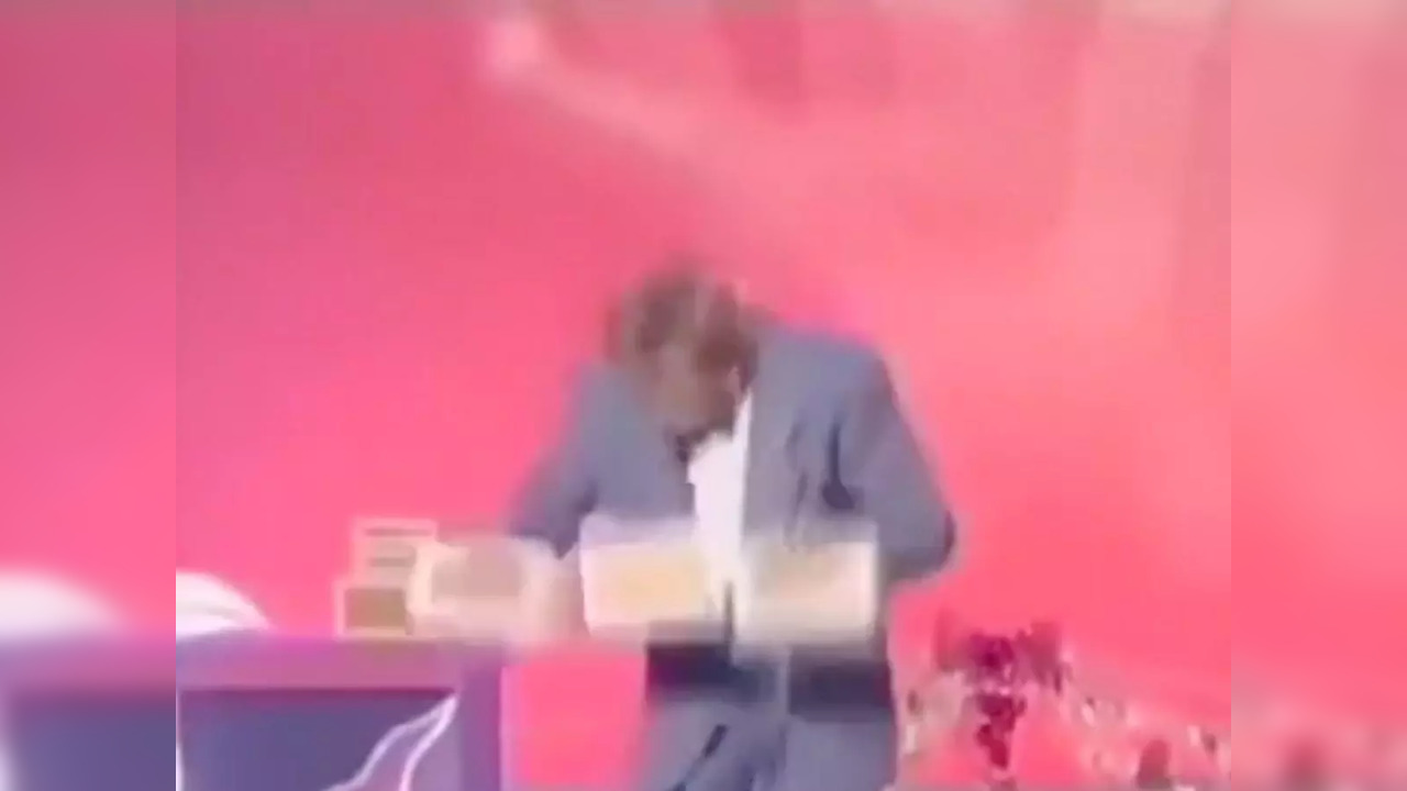 Magician juggles three boxes with two hands