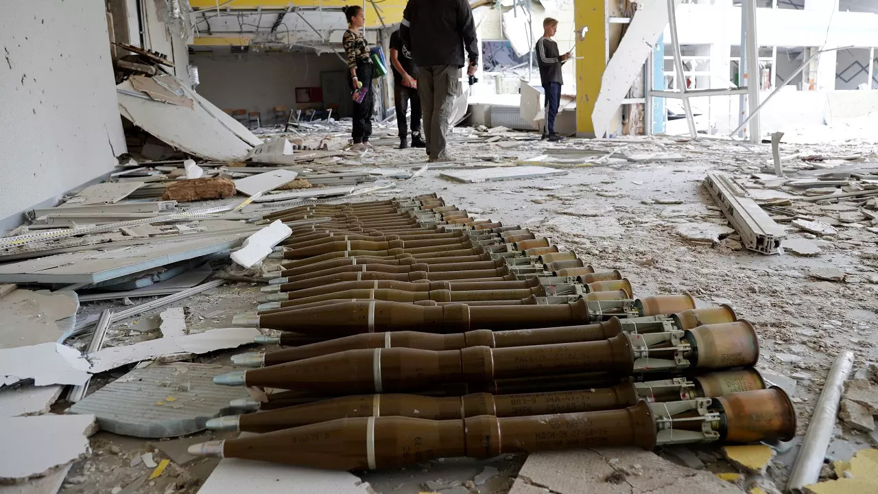 RPG shells lie in the hall of a destroyed school in Mariupol