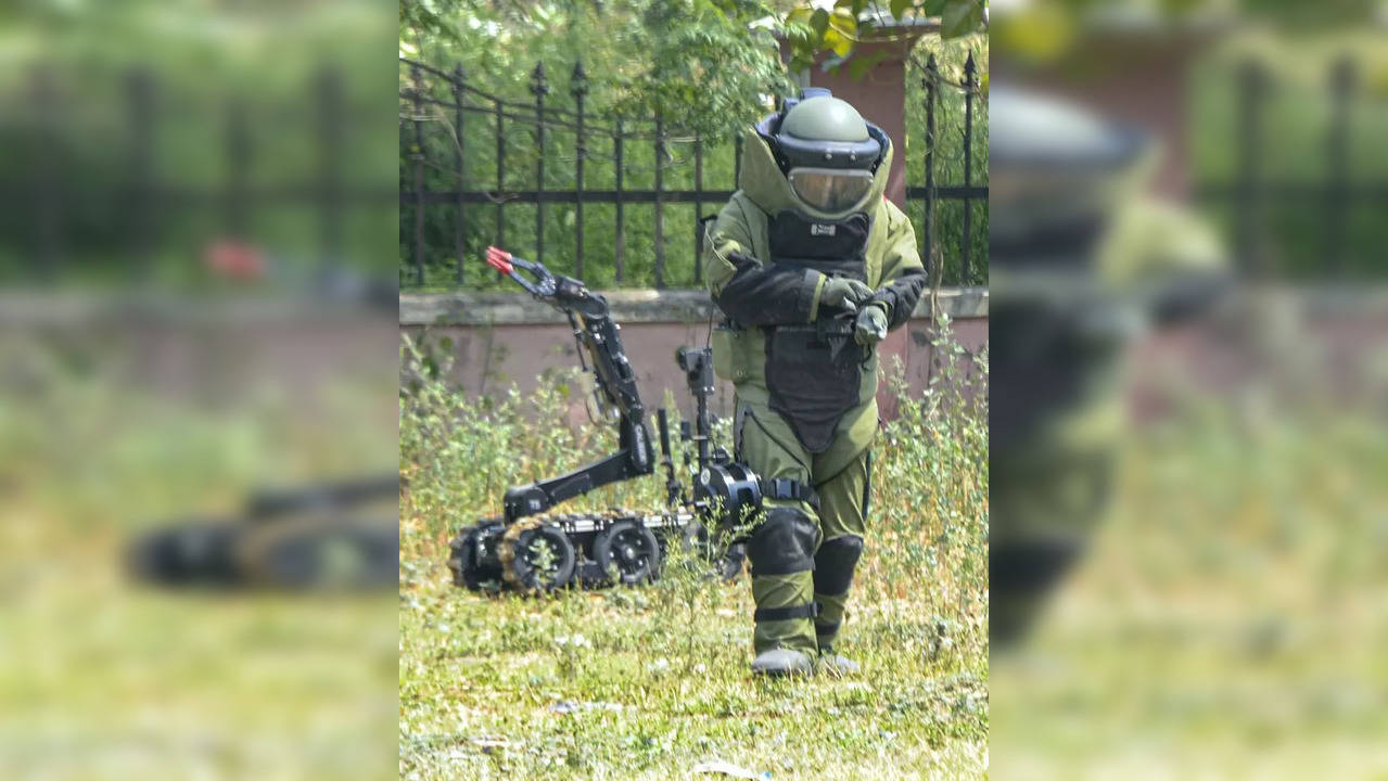 Karnal: A  member of the Bomb Squad attempts to diffuse a cache of explosives, r...