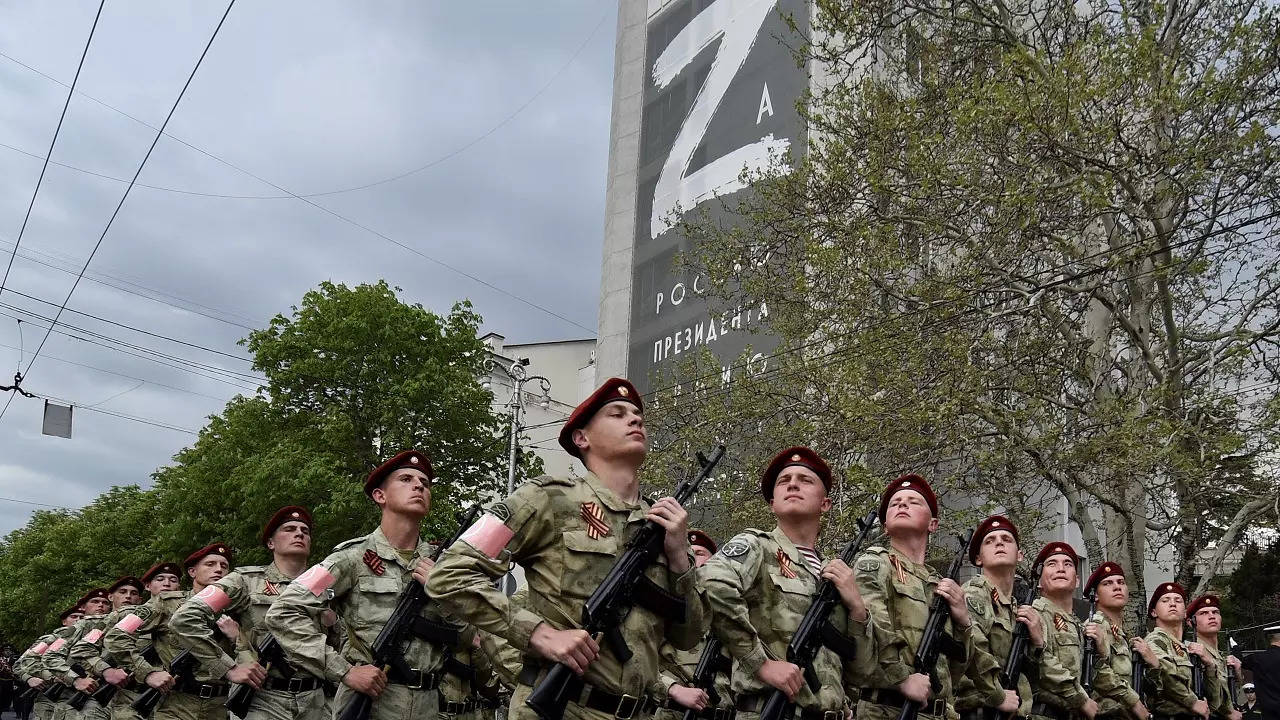 ​Russian National Guard (Rosguardia) servicemen march through a street with a letter Z