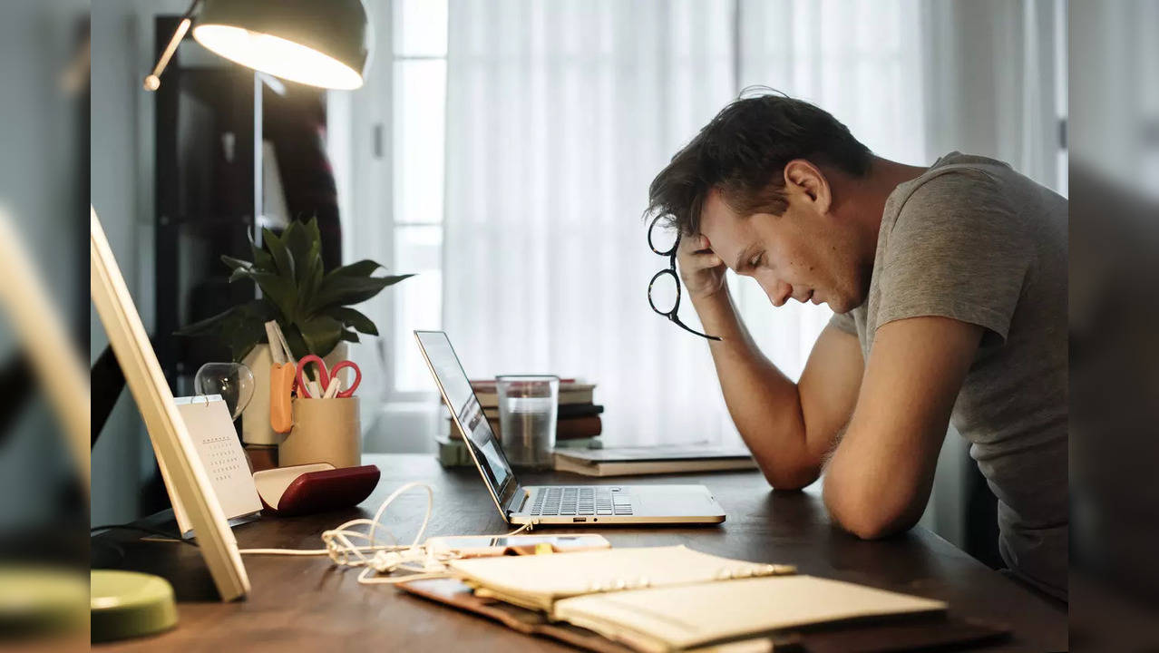 Man stressed while working on laptop