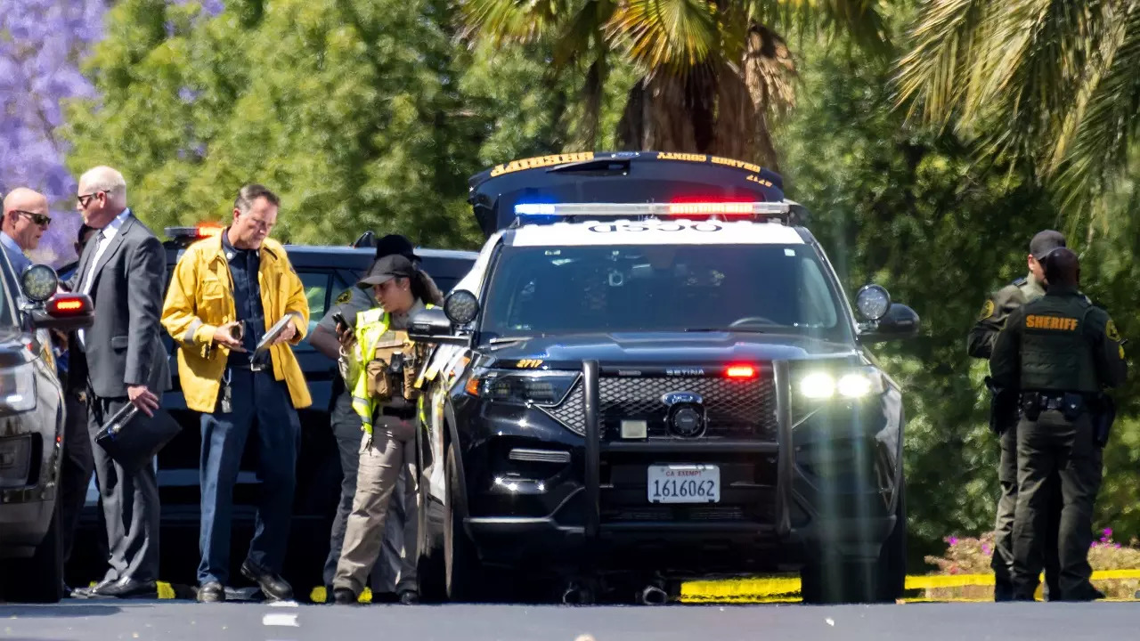 ​Investigators gather outside the Geneva Presbyterian Church in Laguna Woods