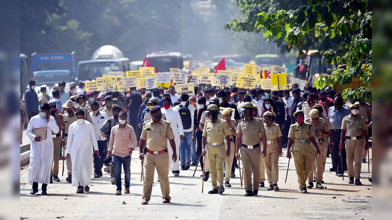 Bengaluru: Police person stand guard as members of Christian community and suppo...