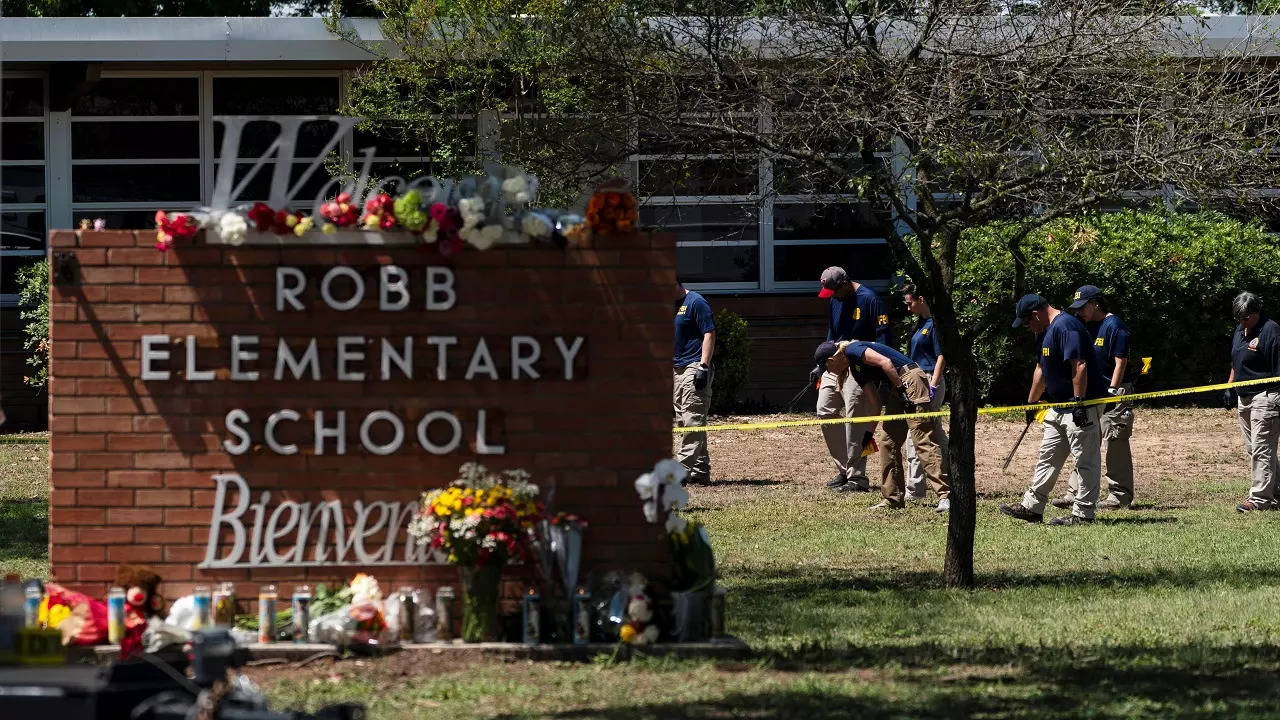 Investigators search for evidences outside Robb Elementary School in Uvalde, Texas, Wednesday, May 25, 2022.