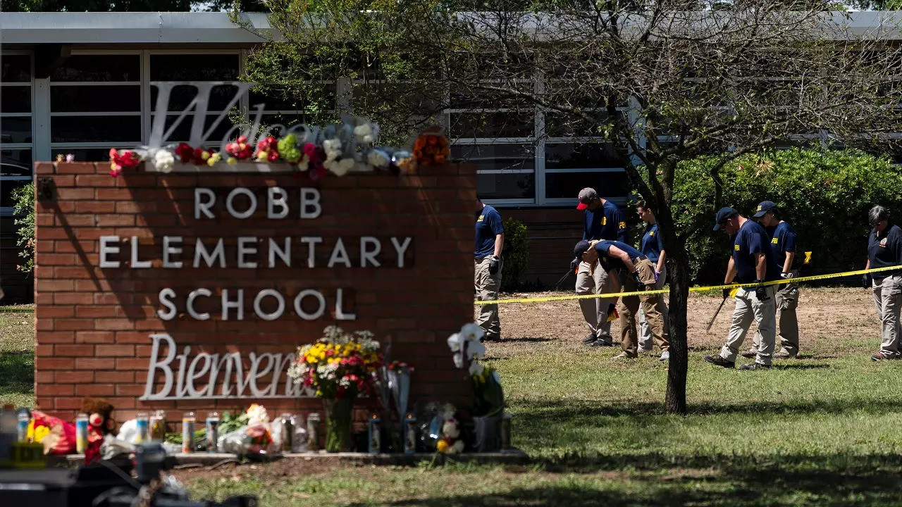 Investigators search for evidences outside Robb Elementary School in Uvalde, Texas, Wednesday, May 25, 2022.