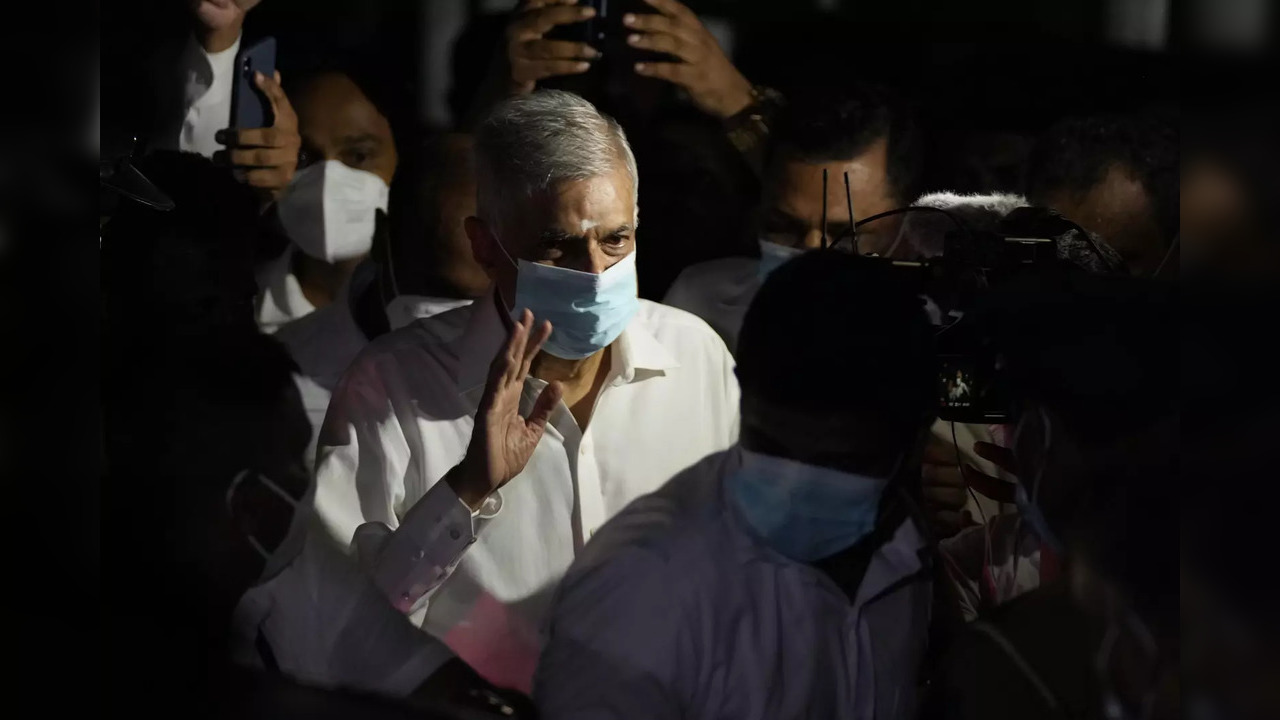 Colombo: Sri Lanka's new prime minister Ranil Wickremesinghe waves as he leaves ...