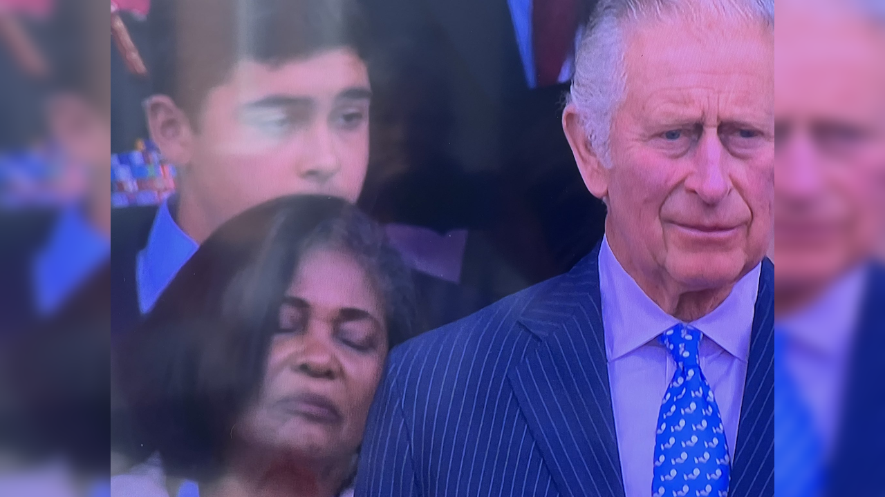 Woman falls asleep behind Prince Charles