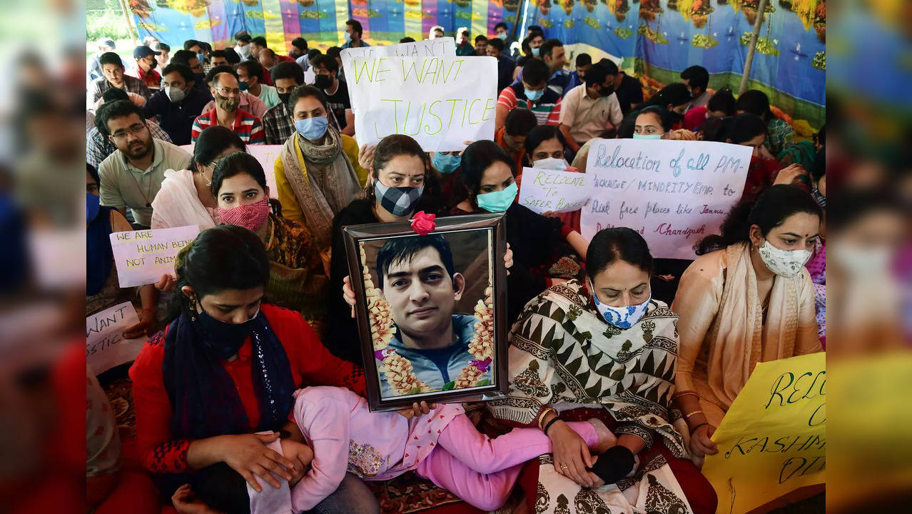 Kashmiri Pandits holding portrait of Rahul Bhat stage a ...