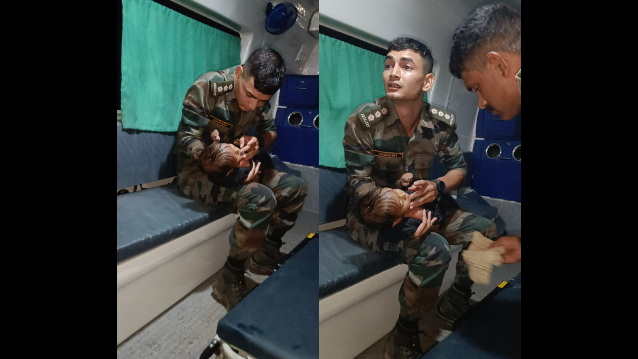 Army officer feeds a baby