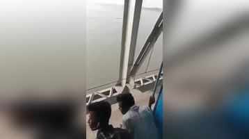 Spider-Man thief Man hanging from bridge snatches passengers phone from moving train in Bihars Begusarai - Watch Viral Video