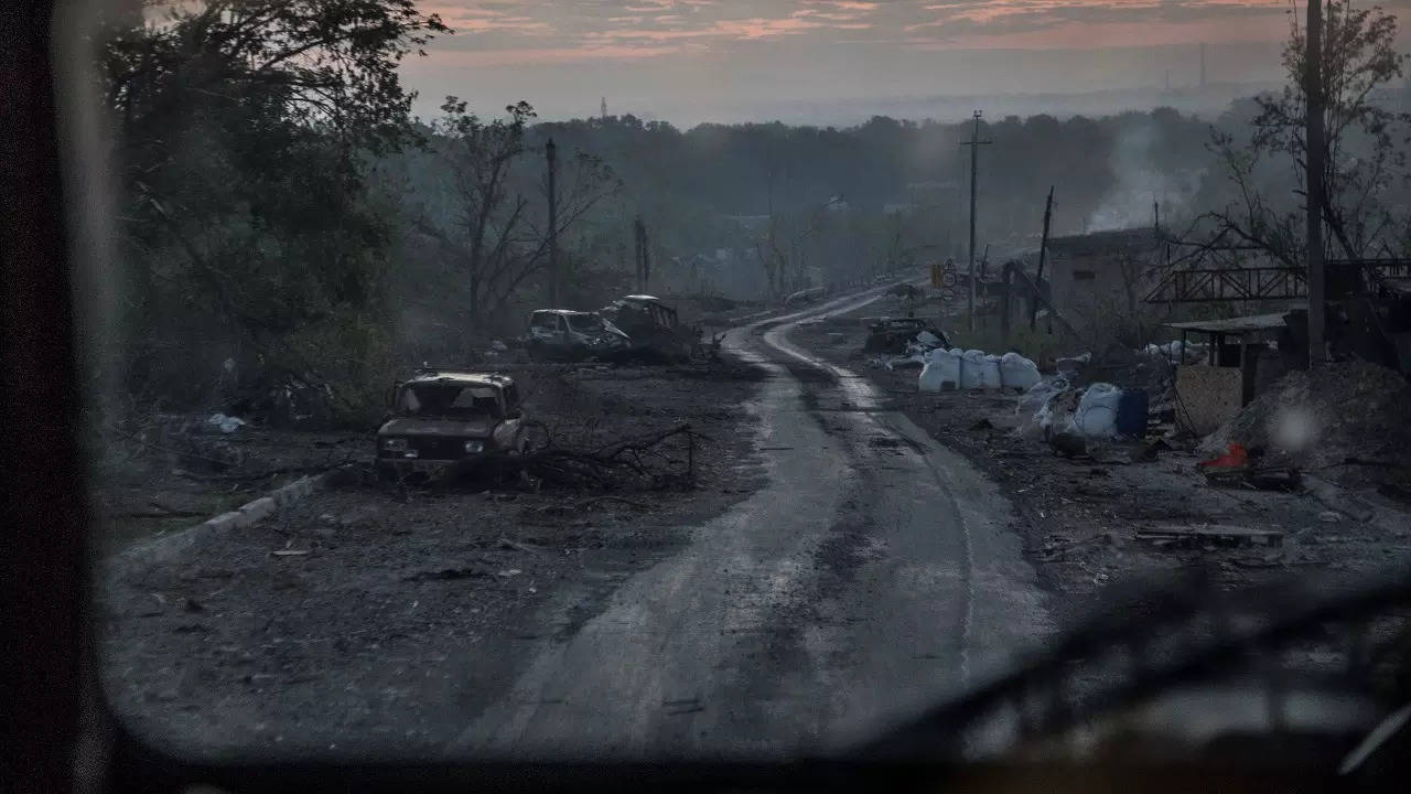 ​The gutted remains of cars lie along a road during heavy fighting at the front line in Severodonetsk