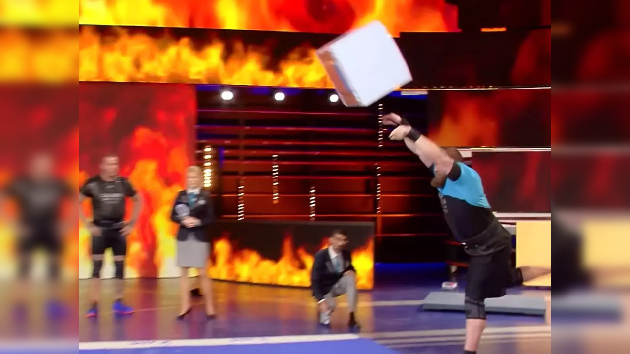 Swedish strongman Johan Espenkron throws a washing machine a distance of 14 feet, 7.2 inches to break a Guinness World Record