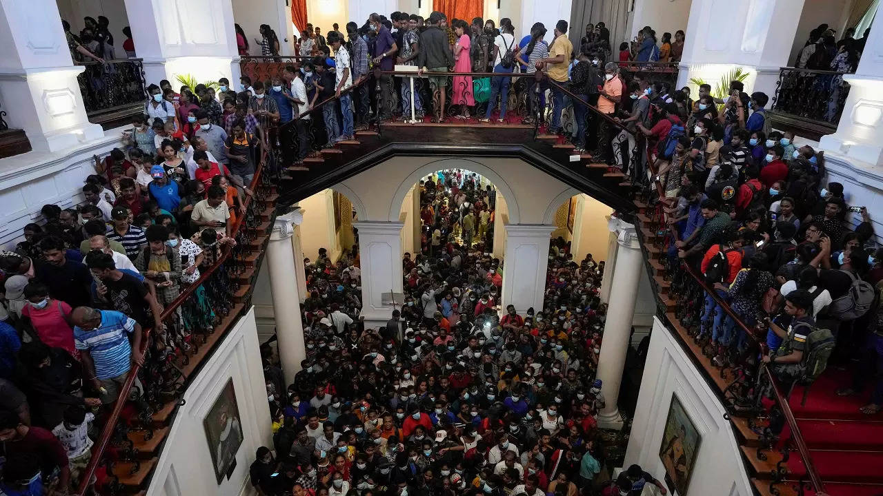 People throng President Gotabaya Rajapaksa’s official residence for the second day after it was stormed in Colombo