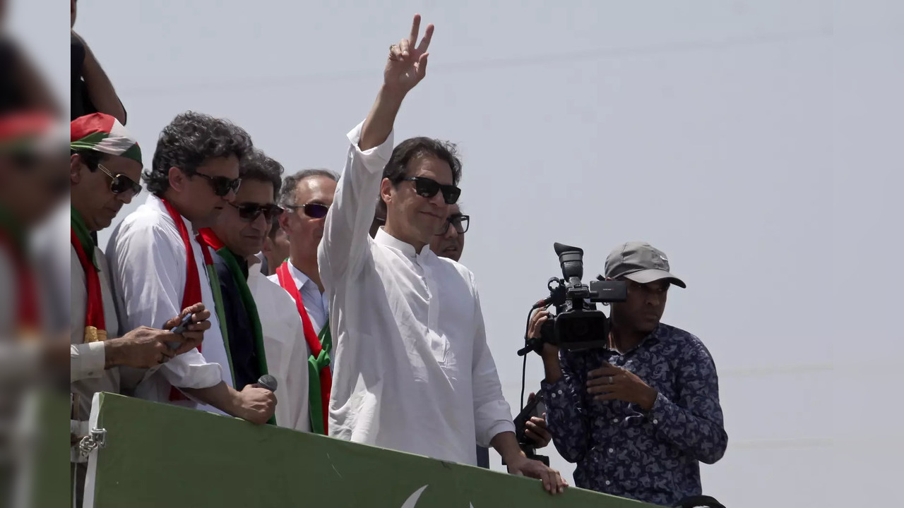 Ousted Pakistani Prime Minister Imran Khan gives the victory sign to supporters ...