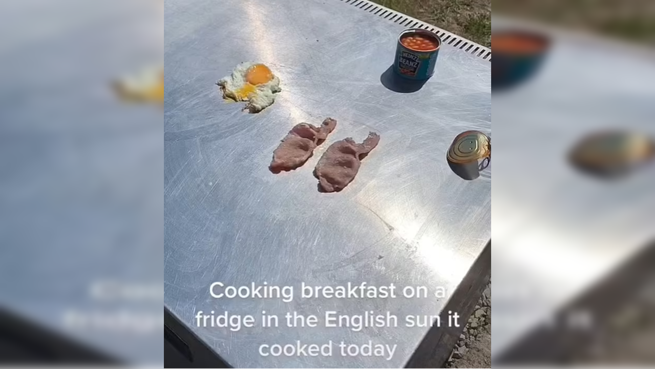 Man cooks breakfast by using heat of the sun