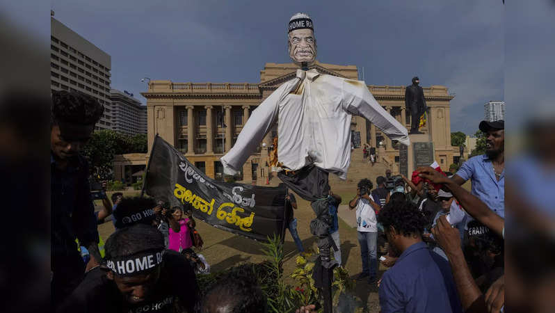 Protestors burn an effigy of acting President and Prime Minister Ranil Wickremes...