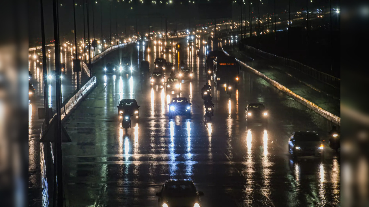 New Delhi: Vehicles ply after monsoon rains, near Akshardham in New Delhi. (PTI ...