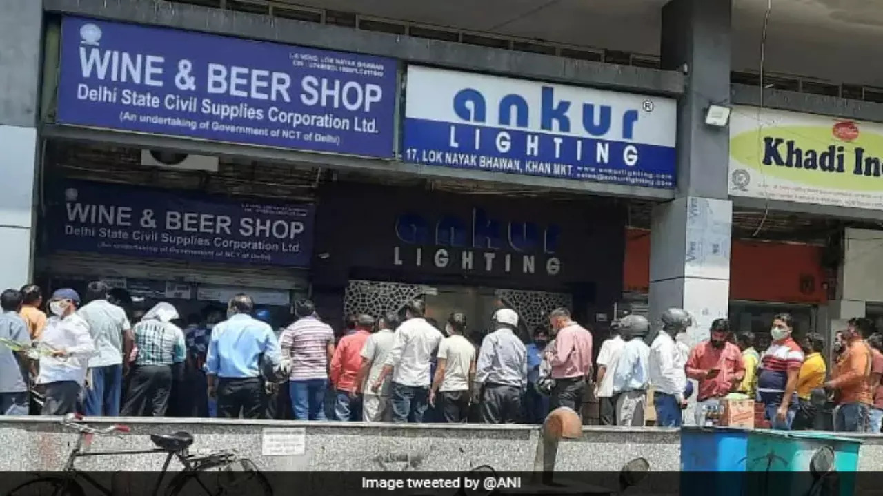 People waiting outside a liquor store in Delhi