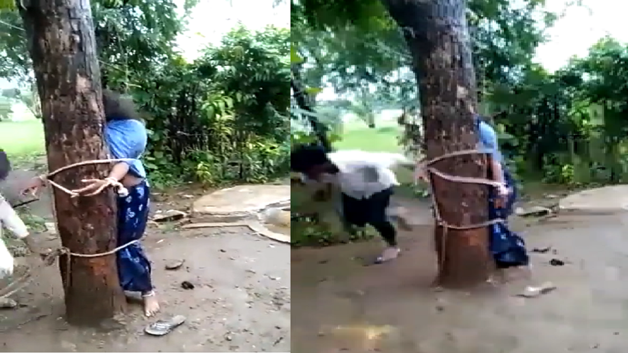 woman tied to tree