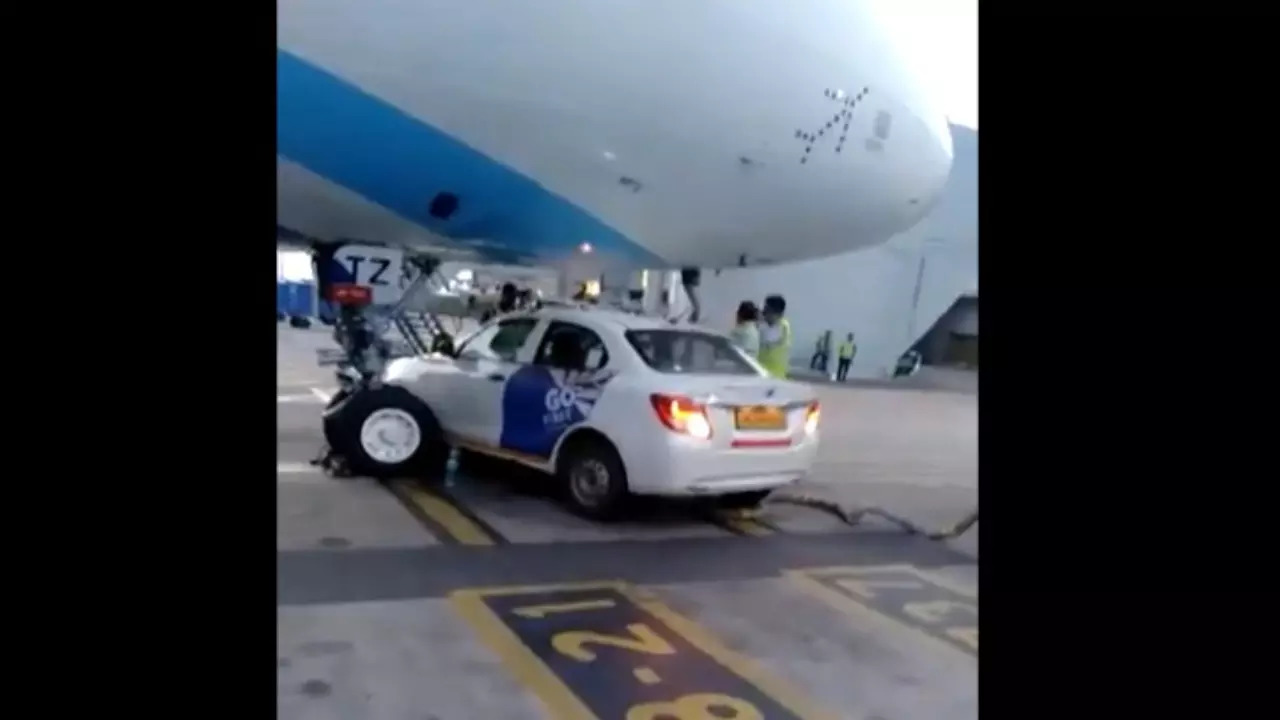 Delhi: A Go Ground Maruti vehicle stopped under the nose area of the Indigo aircraft