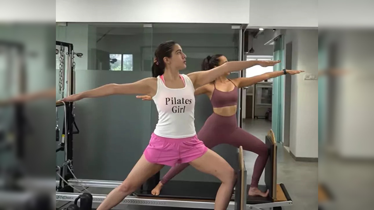 The video begins with Sara Ali Khan practising the Warrior II Pose or Virabhadrasana II on the Cadillac Reformer. She then moves to leg-pumping workouts on Pilates equipment followed by stretching workouts and squats. (Photo credit: Sara Ali Khan/Instagram)