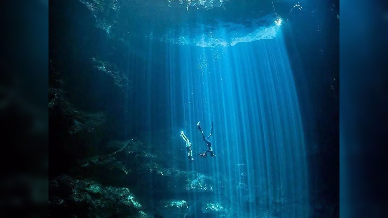 Rays of sunlight illuminate El Pit, a cenote in Yucatan, Mexico | Picture courtesy: @tstgeorge