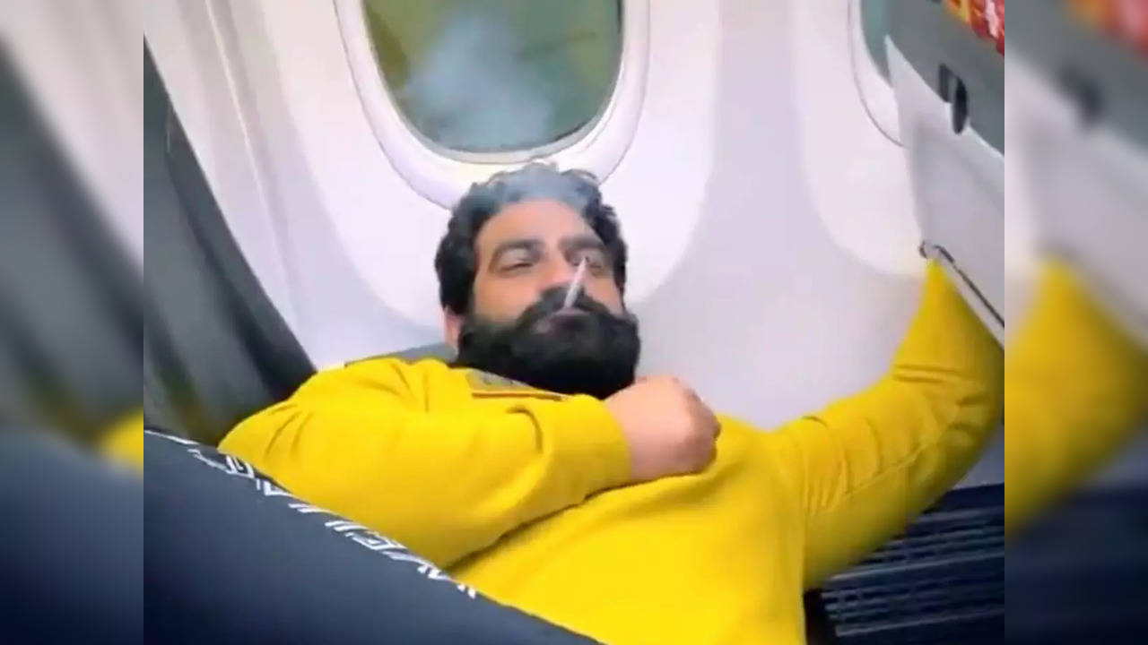 A man wearing pyjamas with the name 'Bobby Kataria' printed on one side was seen smoking on a SpiceJet plane