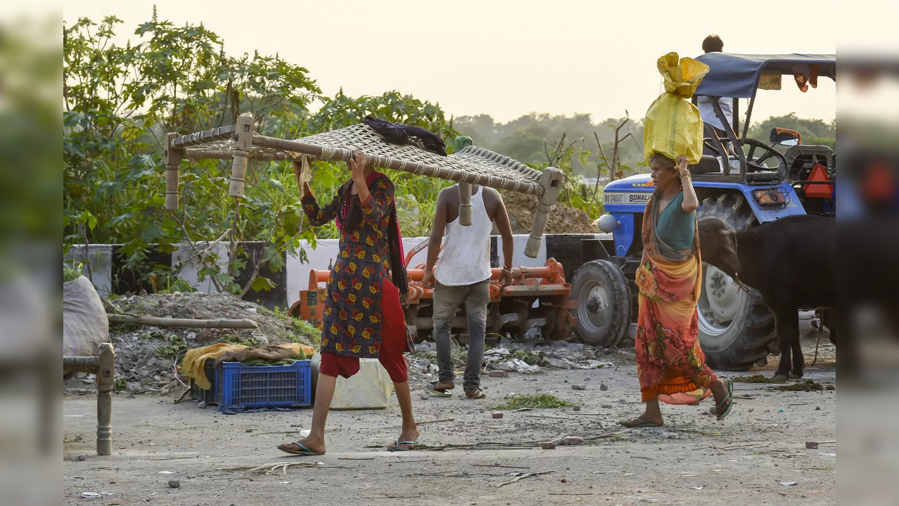 People living on the banks of Yamuna river shift their belongings