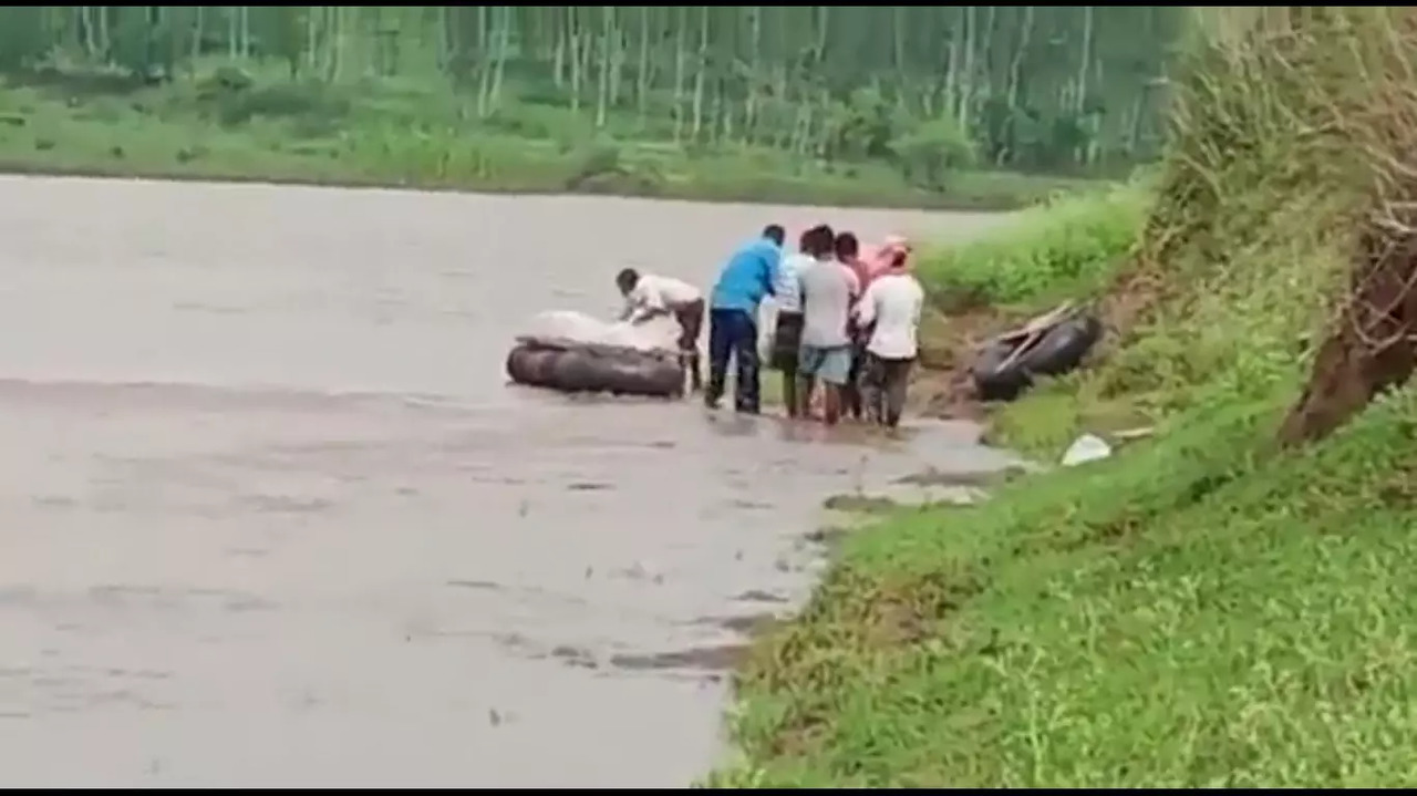 A video shows some people carrying the body across the river to their village in Anuppur district.