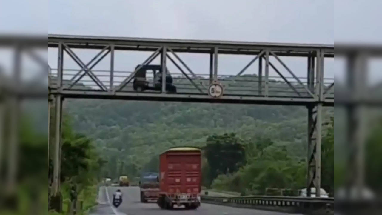 Auto seen driving on footbridge in Maharashtra on National Highway 48 near Virar