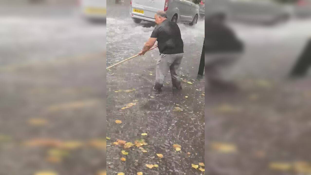 Viral video Man using broom to stop London's flash flooding is 'world's response to climate