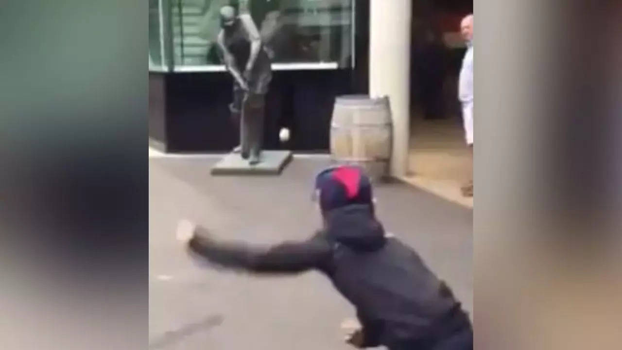 Boy bowling on a street in the UK