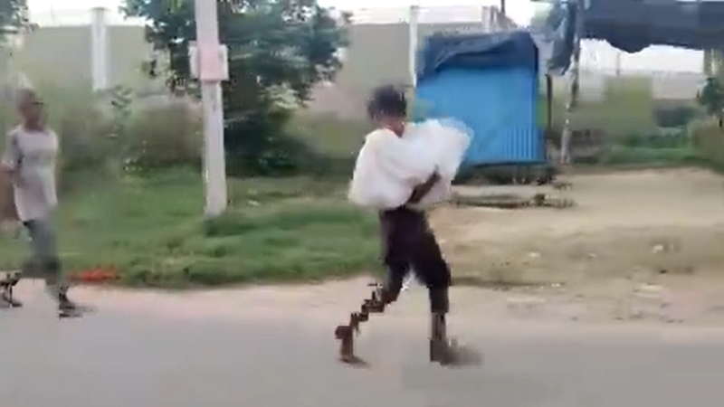 boy carries dead body of two-year-old brother