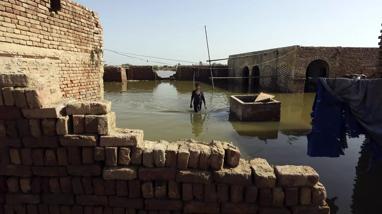 ​A boy wades through floodwaters from monsoon rains in Jaffarabad​