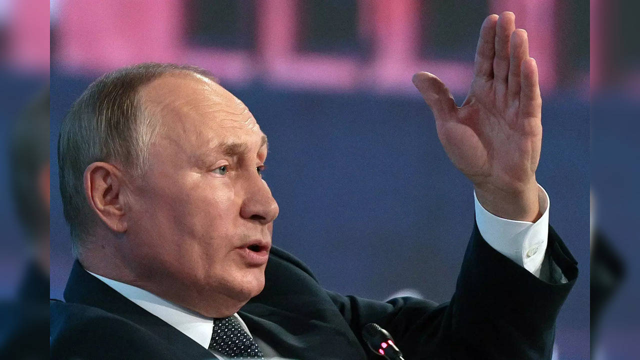 Russian President Vladimir Putin gestures while speaking during a plenary sessio...