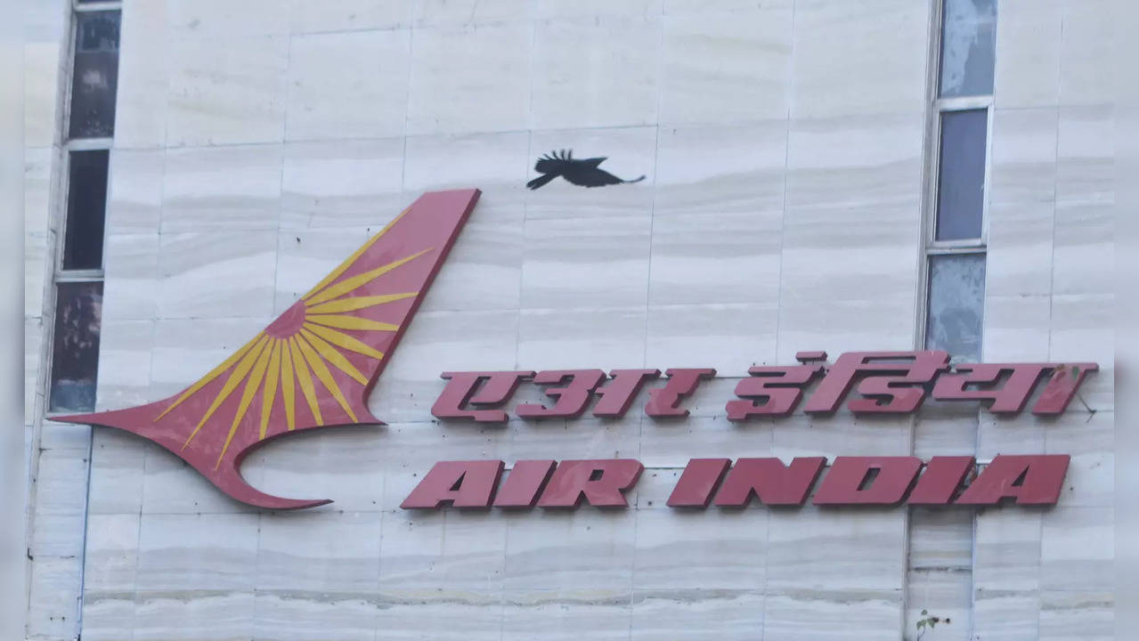 A bird flies over a logo of Air India airlines at the corporate headquarters in Mumbai