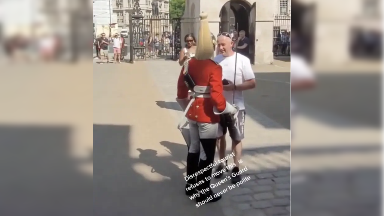 Man stands in the way of Queen's Guard