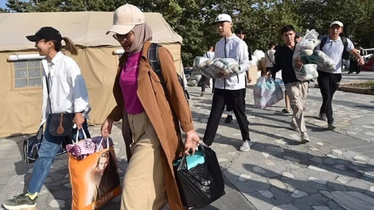 Volunteers carry humanitarian aid for people evacuated from the town of Batken in Bishkek