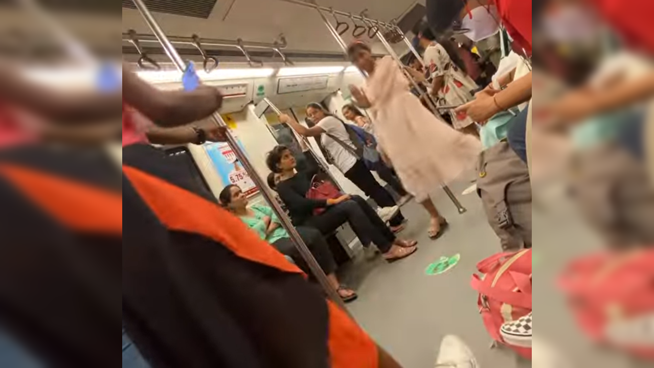 ​Girl dances inside Delhi metro coach