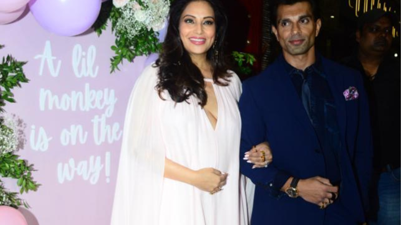 Bipasha Basu cradles her baby bump in breezy gown as she arrives for baby shower with hubby Karan Singh Grover