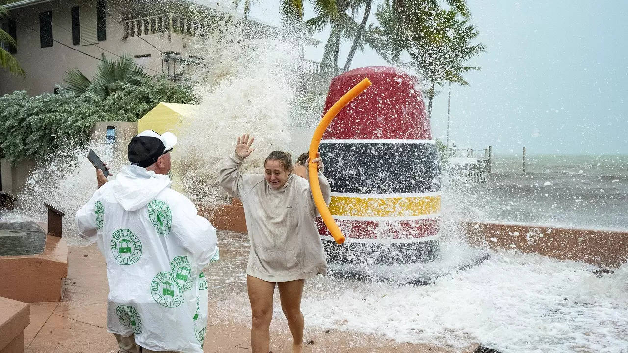 ​Visitors to the Southernmost Point buoy in Key West​, Florida brave the high waves from Hurricane Ian crash for photos on September 27.