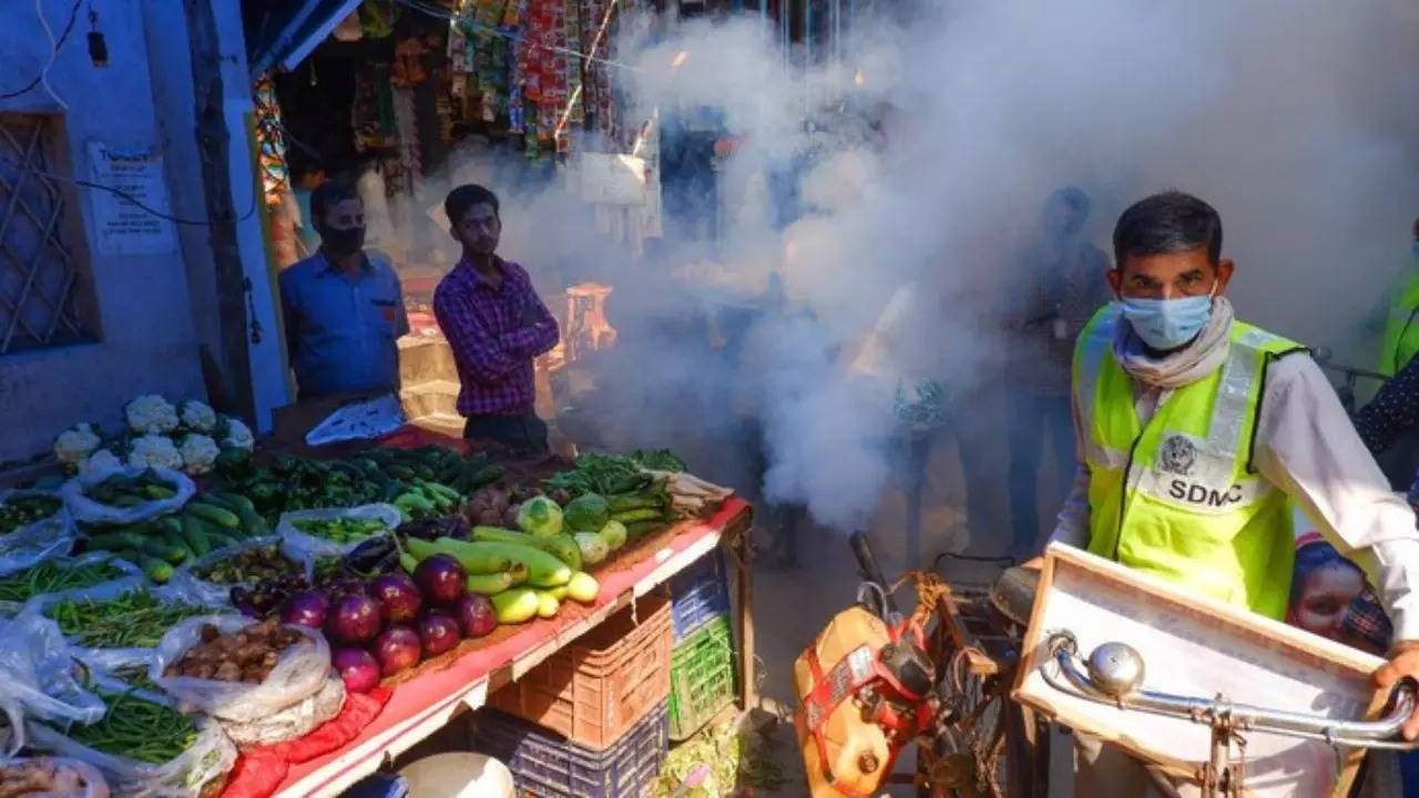 Municipal worker carrying out fumigation in Delhi