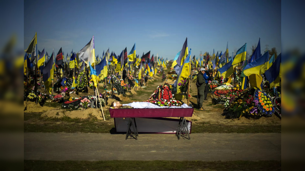 The body of recently killed Ukrainian serviceman Vadim Bereghnuy, 22, rests in a coffin during his funeral in a cemetery in Kharkiv