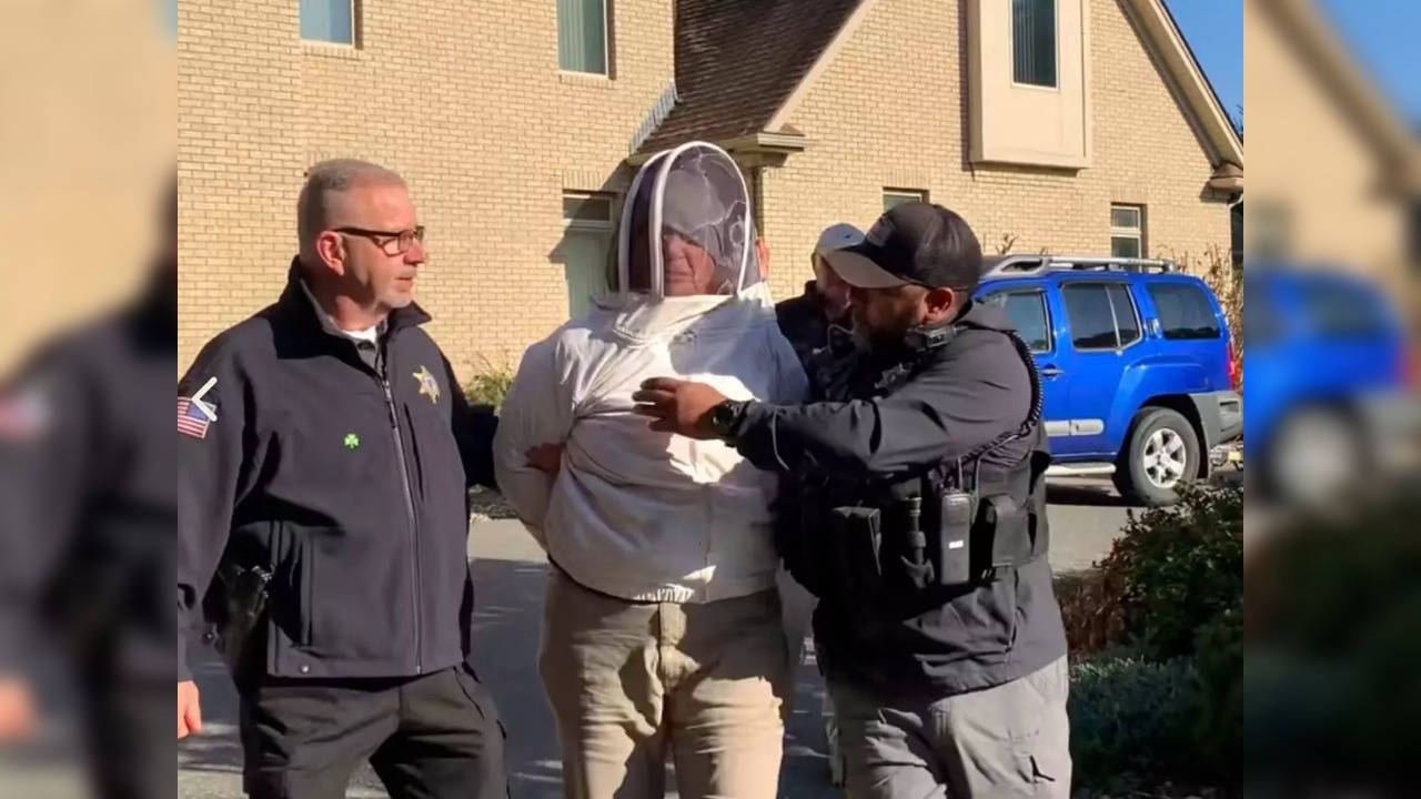 Rorie S. Woods, 55, of Massachusetts, wears a beekeeping suit while being taken into custody | Picture courtesy: Hampden County Sheriff's Department/Local 10