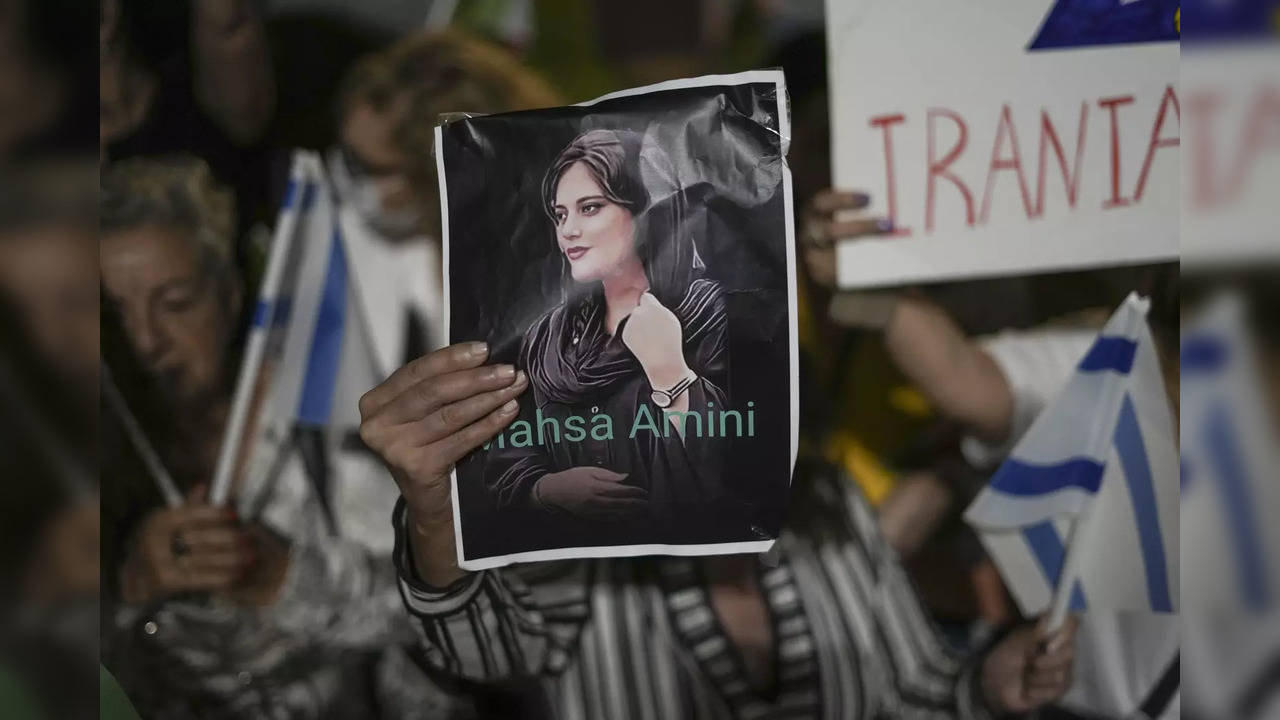 Women attend a protest against the death of Mahsa Amini during a rally in Tel Aviv