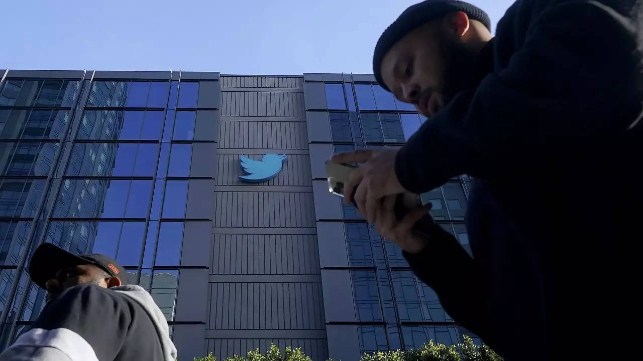 People walk outside Twitter headquarters in San Francisco