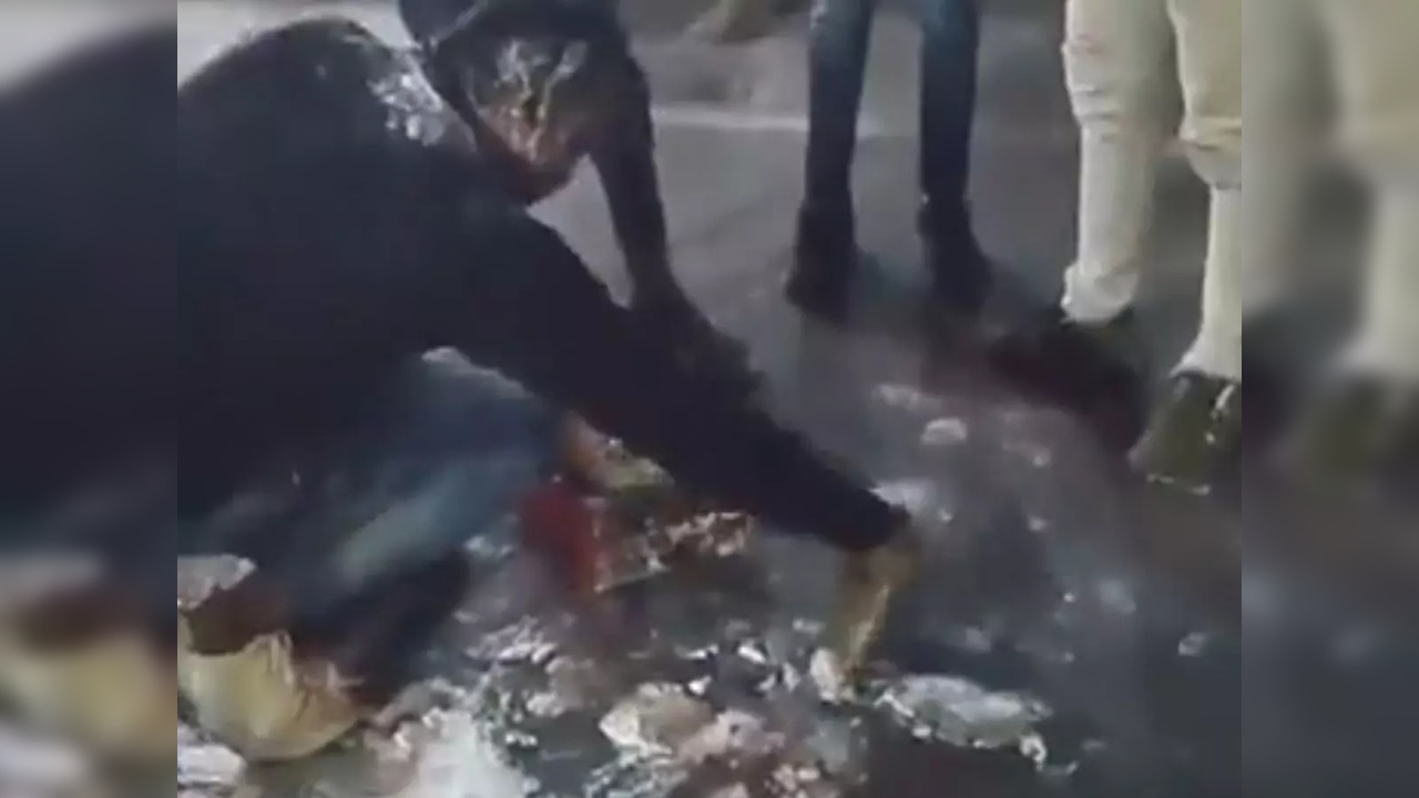 Lucknow: Friends watch on as birthday boy cleans cake off road after police intervenes in messy celebration | Screengrab from video