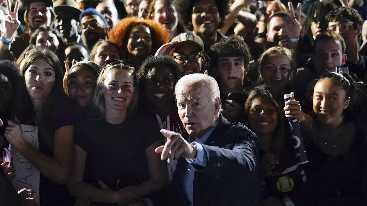 ​President Joe Biden points as he tells members of the crowd where to look to get a photo taken after a campaign event for New York Governor Kathy Hochul​